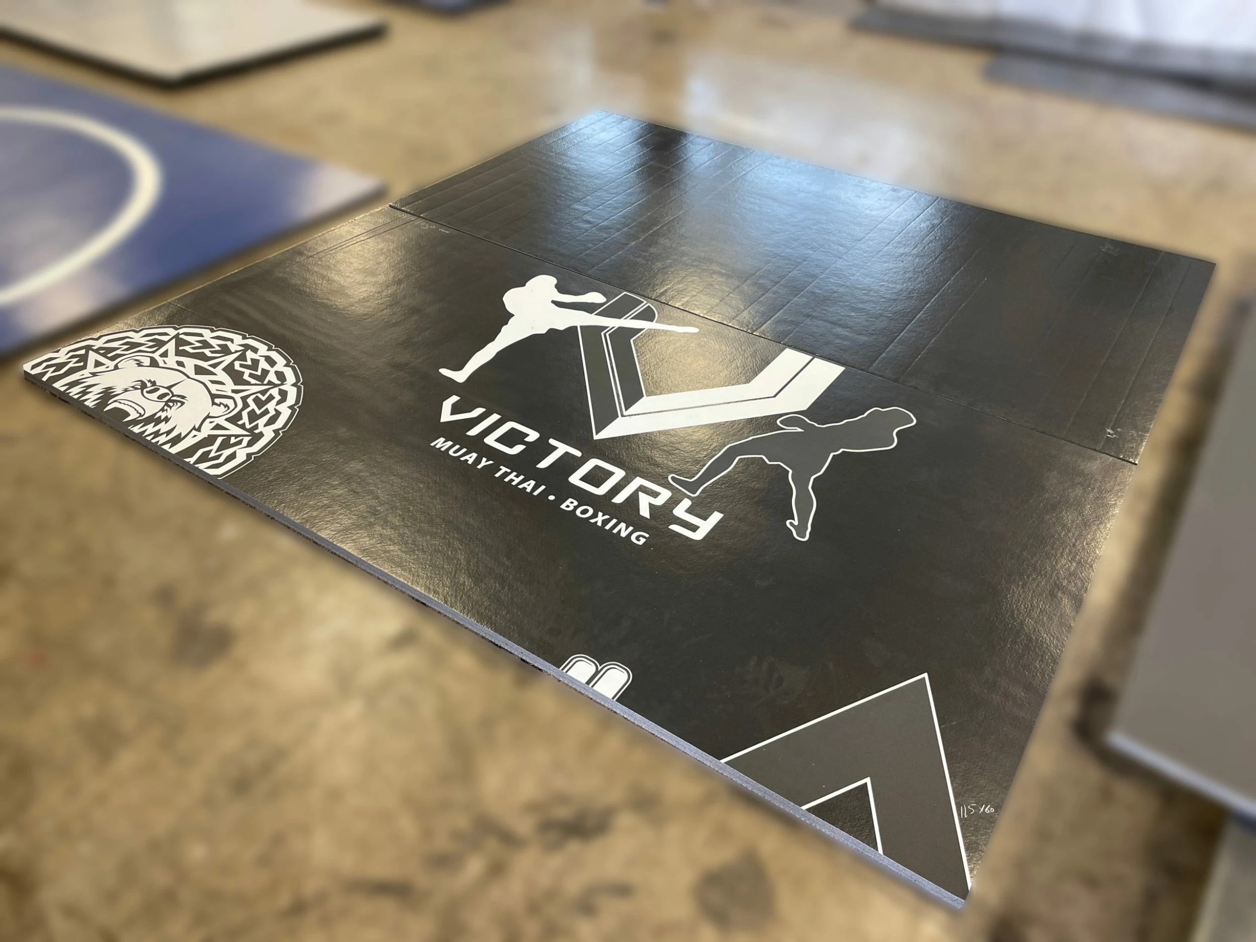 AK Athletic Equipment Clearance 115” X 10’ Black Mat With Logo Error Roll-Up Mat Print Flaw 1 AK Athletic Equipment Clearance 115” X 10’ Black Mat With Logo Error Roll-Up Mat Print Flaw